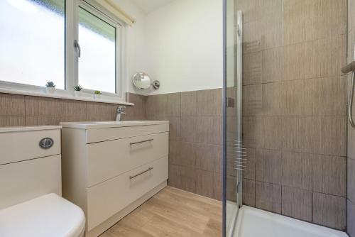 a bathroom with a shower and a toilet and a sink at 2 Bed in Bush oc-b31845 in Bude