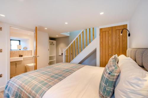 a bedroom with a bed and a staircase at 1 Bed in Austwick oc-b31906 in Horton in Ribblesdale