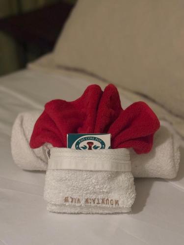 a pile of towels sitting on top of a bed at Mountain View Vacation Home in Petite Soufrière