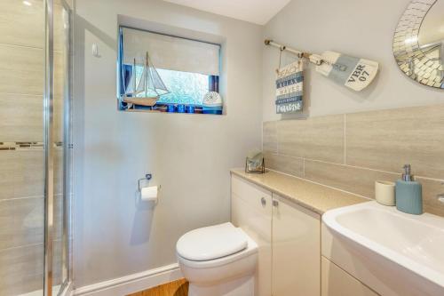 a bathroom with a toilet and a sink and a shower at 2 Bed in Weybourne oc-2151 in Weybourne