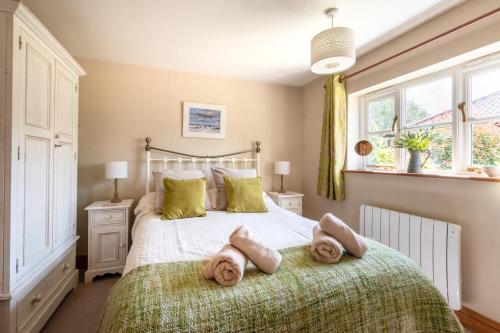a bedroom with a large bed with green pillows at 1 Bed in Swannington oc-1011 in Alderford
