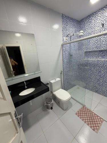 a bathroom with a toilet and a sink and a shower at Pipa House Center in Pipa
