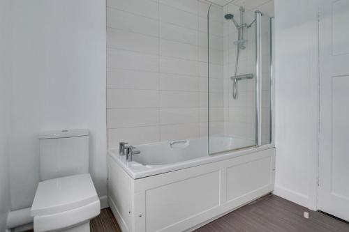 a white bathroom with a shower and a toilet at 2 Bed in Woodbridge oc-g23 in Woodbridge