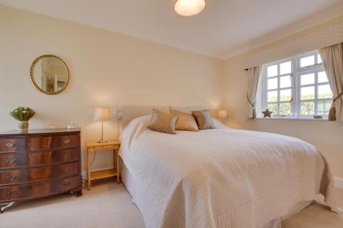 a bedroom with a bed with a dresser and a window at 1 Bed in Tenterden oc-tn623 in Saint Michaels