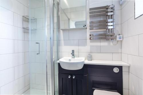 a bathroom with a sink and a shower at 3 Bed in Greatstone oc-ek777 in Littlestone-on-Sea