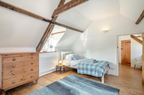 a bedroom with a bed and a dresser in a attic at 2 Bed in East Runton oc-2034 in West Runton