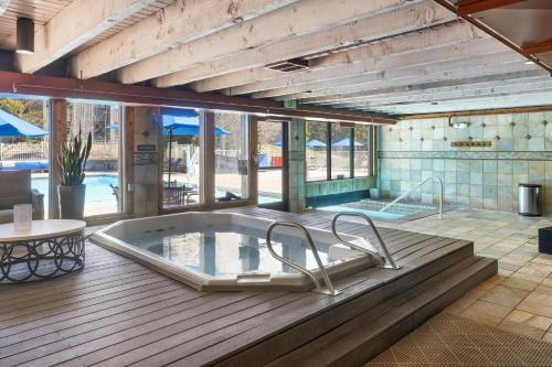 a jacuzzi tub on a deck with a table at River Run Village by Vail Resorts in Keystone