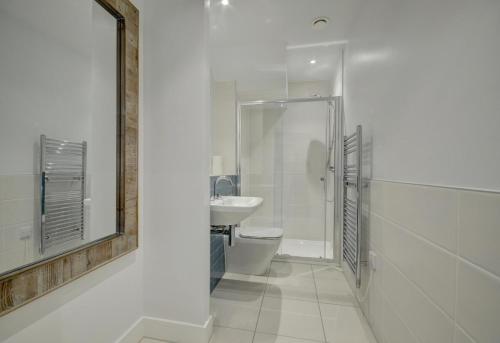 a bathroom with a toilet and a sink and a mirror at 3 Bed in Woolacombe oc-5byron in Woolacombe