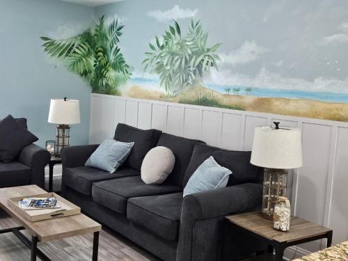 a living room with a couch and a painting on the wall at Seaside Gem in Biloxi