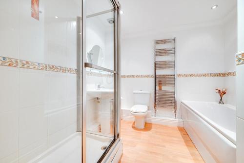 a bathroom with a shower and a toilet and a sink at 2 Bed in Carlyon Bay oc-crinni in Carlyon Bay