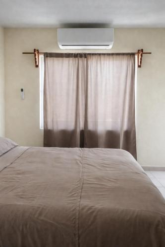a bedroom with a large bed with a window with at Private apartment La Paz baja in La Paz