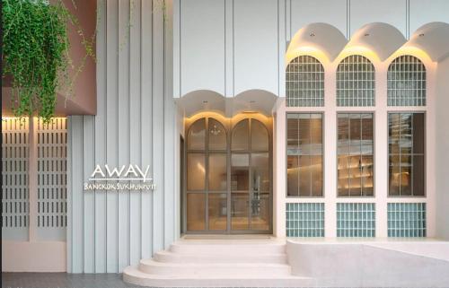 an entrance to a building with a glass door at Away Bangkok Sukhumvit in Bangkok