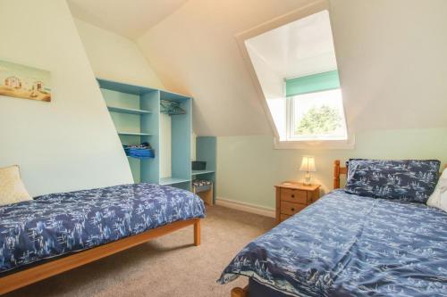 a attic bedroom with a bed and a window at 5 Bed in Runswick oc-wa326 in Runswick