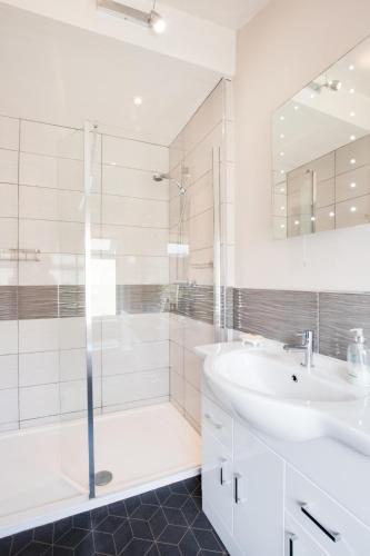 a white bathroom with a sink and a shower at 5 Bed in Runswick oc-wa326 in Runswick