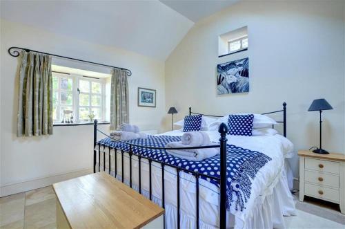 a bedroom with a bed with blue and white pillows at 2 Bed in Menai Bridge oc-fl046 in Llandegfan