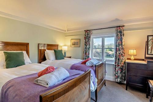 a bedroom with two beds and a window at 6 Bed in Wymondham oc-t30598 in Wymondham