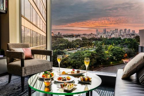 a room with a table with food and glasses of wine at Hotel New Otani Tokyo EXECUTIVE HOUSE ZEN in Tokyo