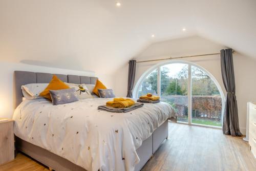 a bedroom with a large bed with a large window at 1 Bed in Tasburgh oc-t28242 in Ashwellthorpe