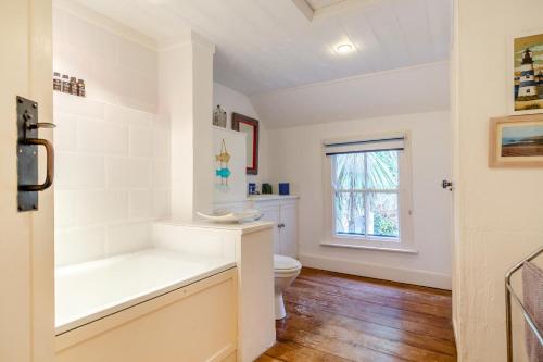 a white bathroom with a toilet and a tub at 5 Bed in Little Petherick oc-melynw in Little Petherick