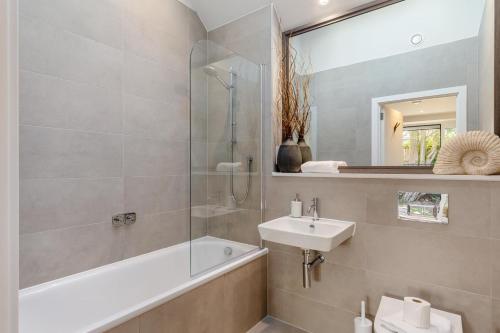 a bathroom with a sink and a tub and a shower at 2 Bed in Padstow oc-t29016 in Padstow