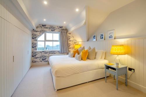 a white bedroom with a bed and a window at 6 Bed in Abersoch oc-c29569 in Abersoch