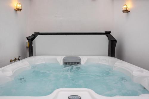 a jacuzzi tub in a room with two lights at 6 Bed in Abersoch oc-c29569 in Abersoch