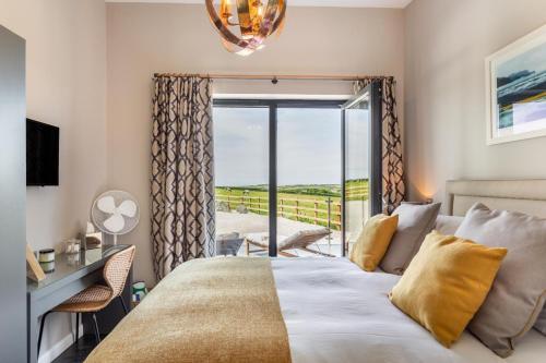 a bedroom with a bed and a balcony at 3 Bed in Hartland oc-w29797 in Hartland