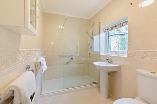 a bathroom with a shower and a toilet and a sink at 3 Bed in Loweswater oc-w30224 in Loweswater