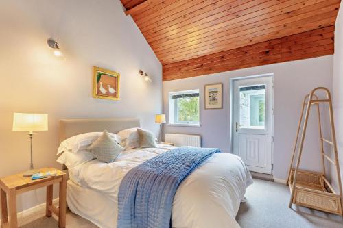a bedroom with a bed and a wooden ceiling at 3 Bed in Loweswater oc-w30224 in Loweswater