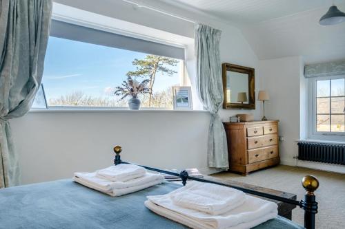 a bedroom with a bed and a large window at 3 Bed in Chale oc-s30298 in Chale