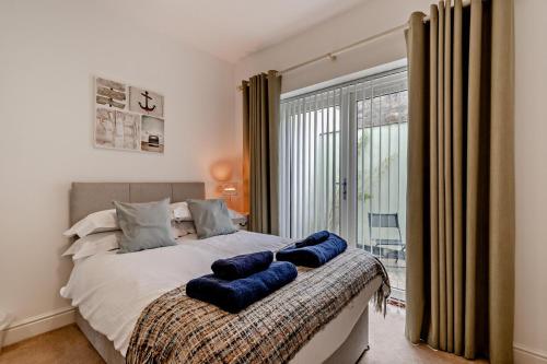 a bedroom with a bed with blue pillows on it at 5 Bed in Sardis oc-m28337 in Saundersfoot
