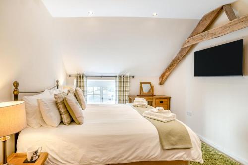 a bedroom with a large bed and a flat screen tv at 2 Bed in Trecastle oc-c30837 in Trecastle