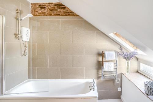 a bathroom with a bath tub in a stair room at 2 Bed in Trecastle oc-c30837 in Trecastle
