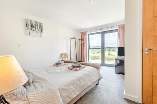 a white bedroom with a bed and a window at 3 Bed in Hythe oc-s32090 in Hythe