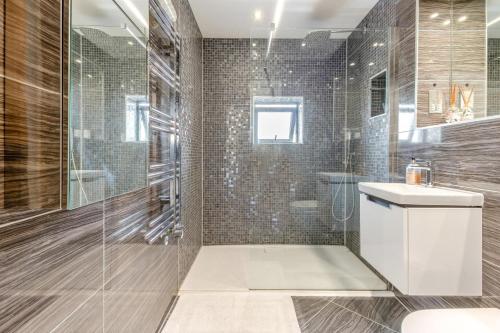 a bathroom with a shower and a toilet and a sink at 3 Bed in Hythe oc-s32090 in Hythe