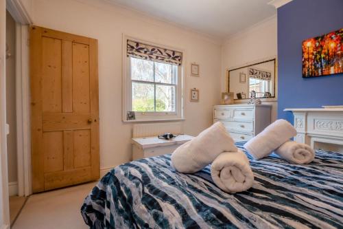 a bedroom with a bed with towels on it at 2 Bed in Wimborne oc-s30924 in Wimborne Minster