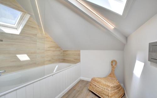 a bathroom with a bath tub and a chair at 2 Bed in Crackington Haven oc-p00596 in Crackington Haven