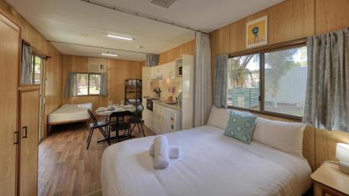 a small room with a bed and a kitchen at BIG4 Barham Holiday Park in Barham