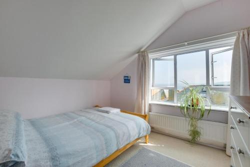 a bedroom with a bed and a large window at 3 Bed in St. Ives oc-virg14 in St Ives