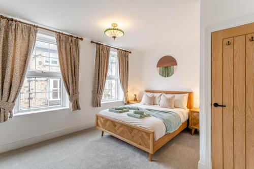 a bedroom with a bed and two windows at 2 Bed in Knaresborough oc-w31758 in Knaresborough