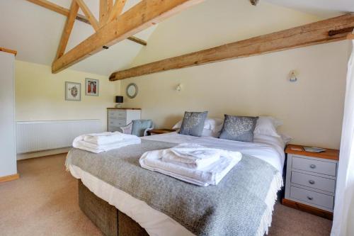 a bedroom with a bed with towels on it at 3 Bed in Thursford oc-1793 in Thursford