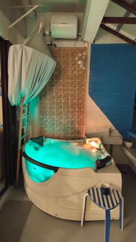 a room with a bath tub and a bed and a bed istg at SunsetSpa PD in Port Dickson