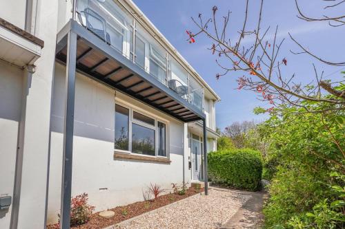 a white house with a window and bushes at 3 Bed in West Lulworth oc-h29362 in West Lulworth