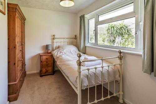 a bedroom with a bed and a window at 3 Bed in West Lulworth oc-h29362 in West Lulworth