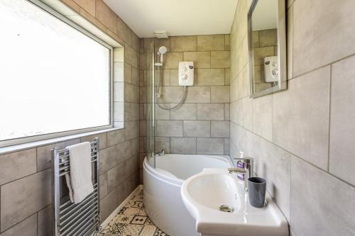 a bathroom with a sink and a bath tub at 3 Bed in West Lulworth oc-h29362 in West Lulworth