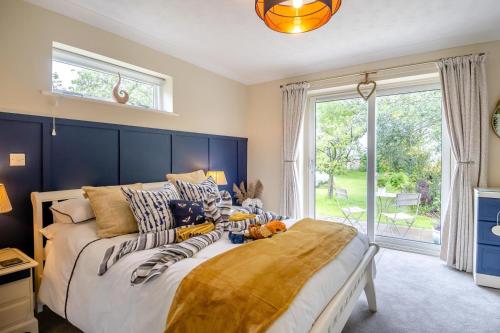 a bedroom with a bed and a large window at 1 Bed in North Walsham oc-f29380 in North Walsham