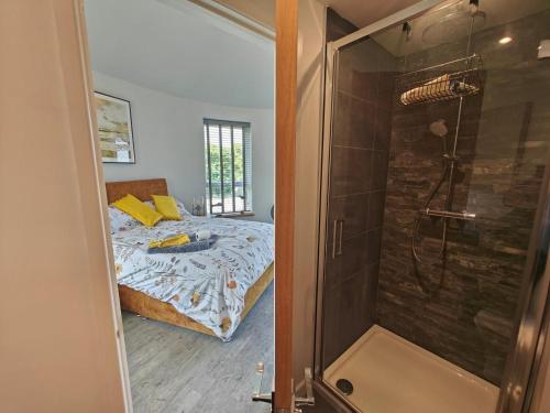 a bedroom with a bed and a shower at 1 Bed in Creech oc-g29728 in Kimmeridge