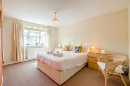 a bedroom with a bed and a chair and a window at 3 Bed in Hawes oc-s30429 in Hawes