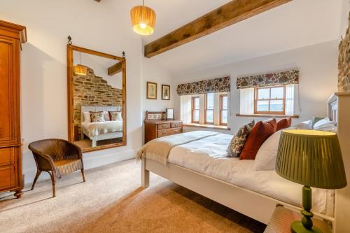 a bedroom with a large bed and a mirror at 4 Bed in Cowling oc-h30773 in Cowling