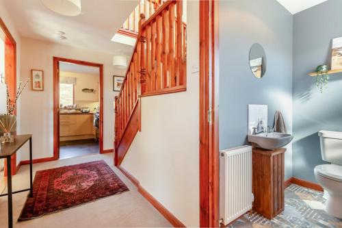 a bathroom with a toilet and a sink at 3 Bed in Strathkanaird oc-r30948 in Ullapool